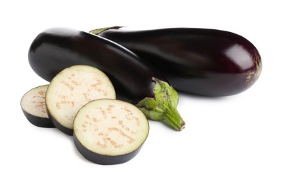 Photo of Whole and cut fresh eggplants isolated on white