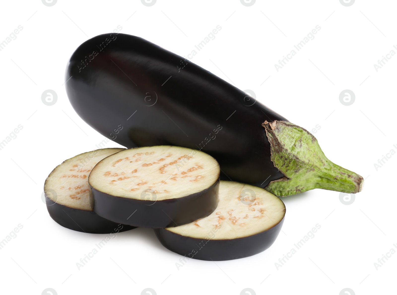 Whole and cut fresh eggplants isolated on white Photo of Whole and cut fresh eggplants isolated on white