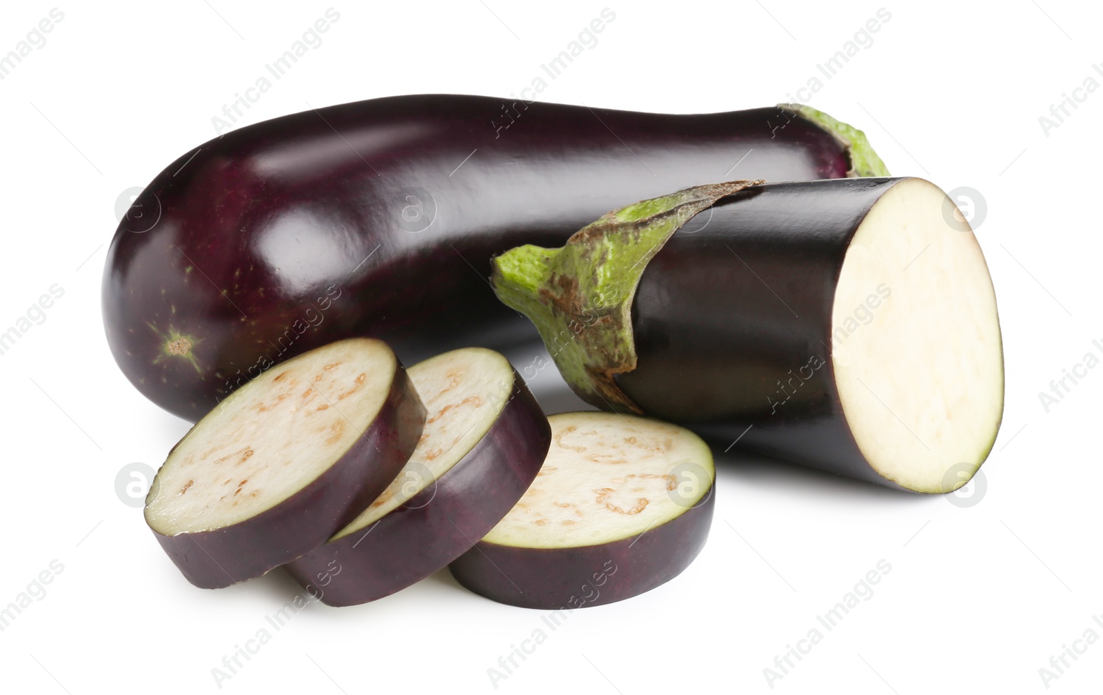 Whole and cut fresh eggplants isolated on white Photo of Whole and cut fresh eggplants isolated on white