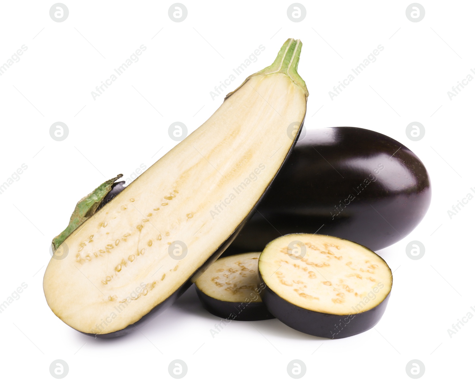 Whole and cut fresh eggplants isolated on white Photo of Whole and cut fresh eggplants isolated on white