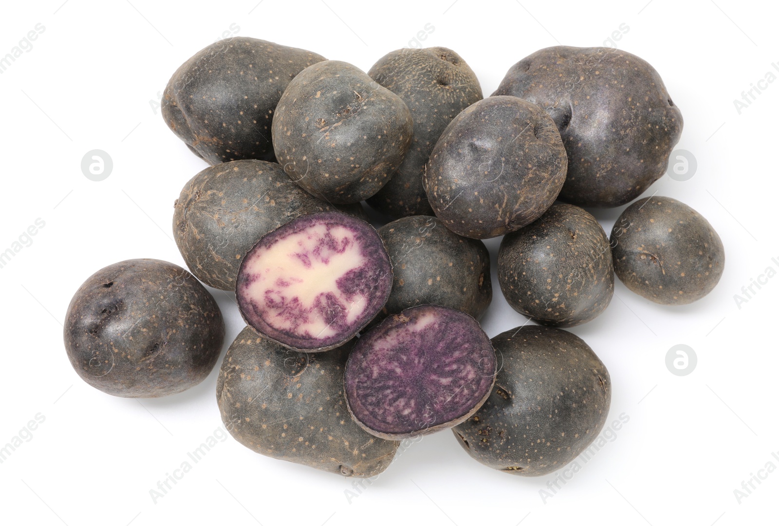 Photo of Whole and cut fresh purple potatoes isolated on white, top view