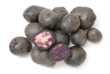 Photo of Whole and cut fresh purple potatoes isolated on white, top view