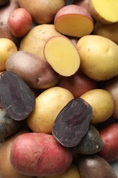 Photo of Different types of potatoes as background, top view