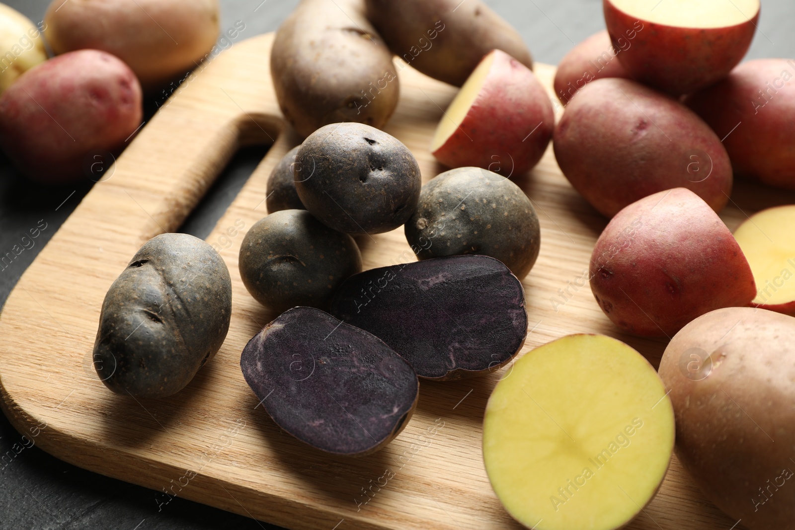 Photo of Different types of potatoes on table, closeup