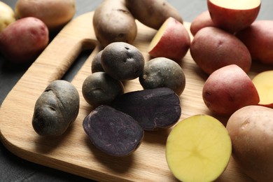 Photo of Different types of potatoes on table, closeup