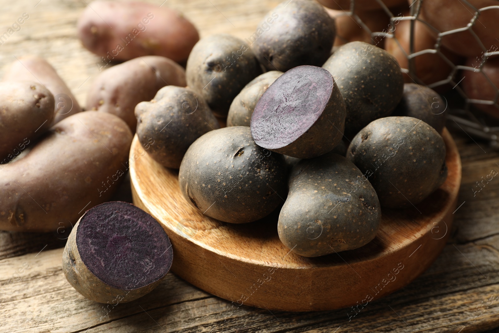 Different types of potatoes on wooden table, closeup Photo of Different types of potatoes on wooden table, closeup