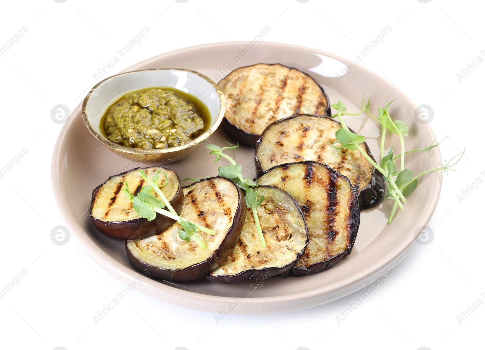 Photo of Grilled slices of eggplant with sauce and microgreens isolated on white