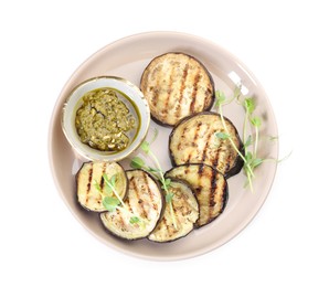 Photo of Grilled slices of eggplant with sauce and microgreens isolated on white, top view