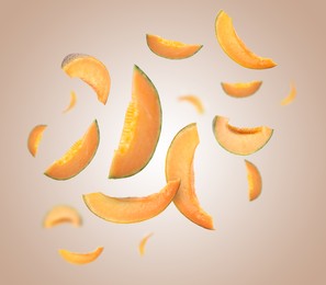 Image of Cut fresh ripe melons swirling in air against color gradient background
