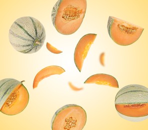Image of Tasty ripe Cantaloupe melons swirling in air against yellow gradient background