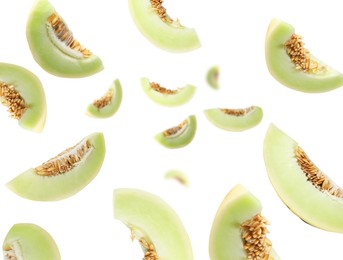 Image of Cut fresh ripe melons swirling in air against white background