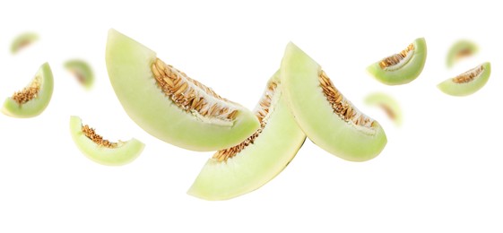 Image of Cut fresh ripe melons swirling in air against white background
