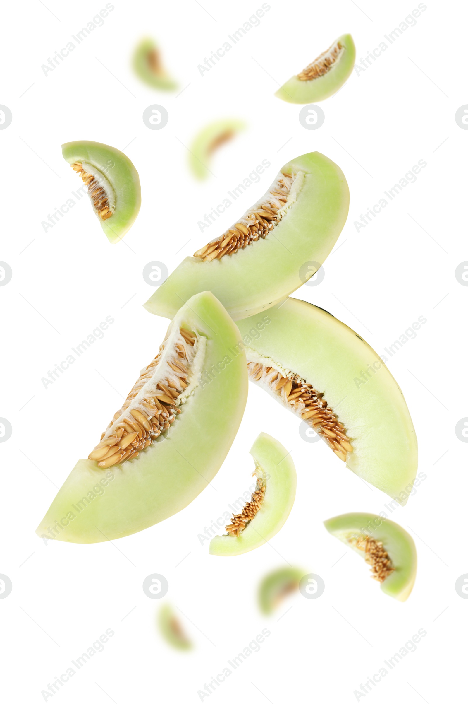 Cut fresh ripe melons swirling in air against white background Image of Cut fresh ripe melons swirling in air against white background