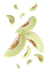 Image of Cut fresh ripe melons swirling in air against white background