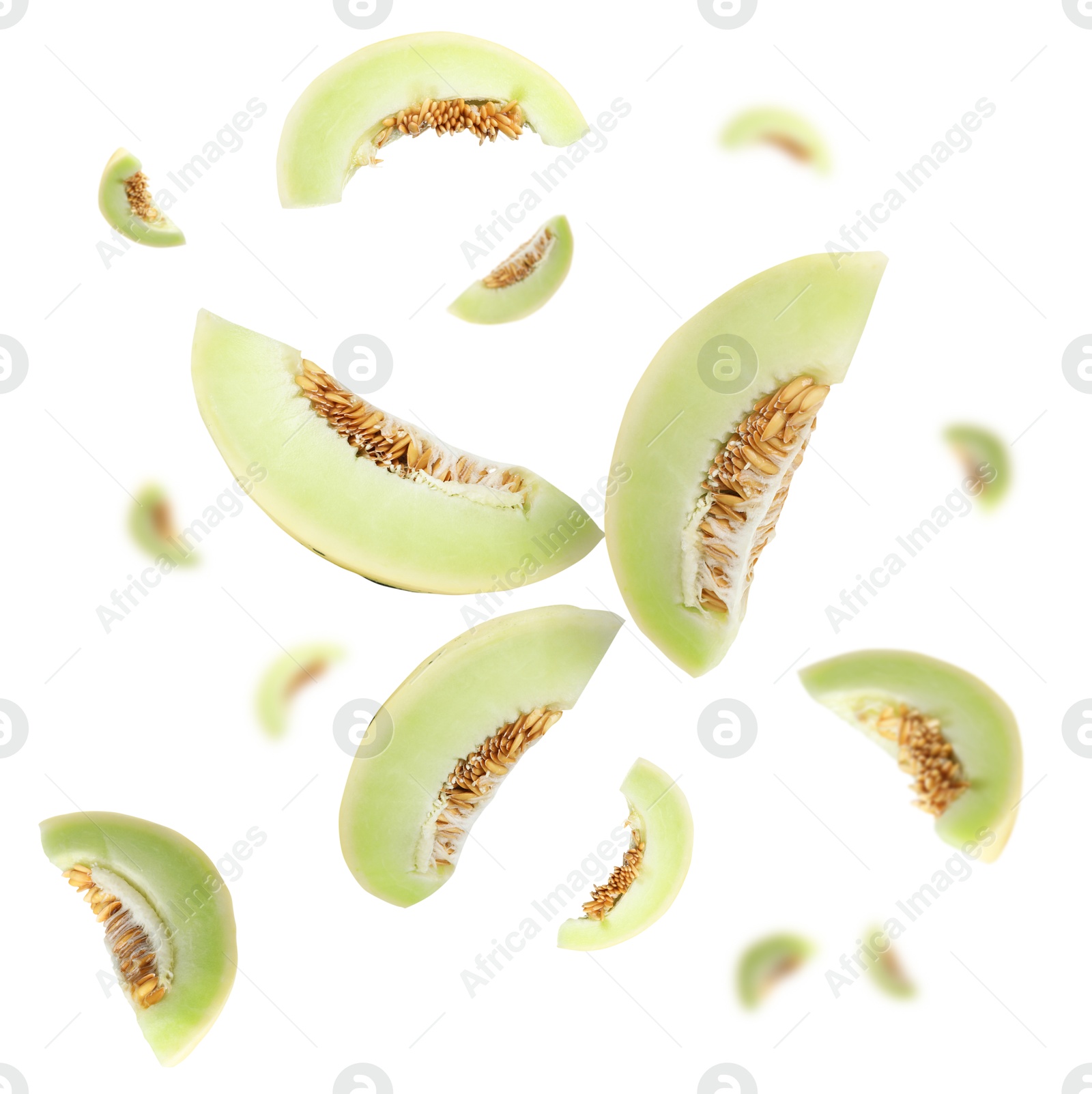 Cut fresh ripe melons swirling in air against white background Image of Cut fresh ripe melons swirling in air against white background