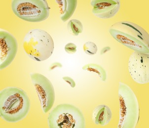 Image of Tasty ripe melons swirling in air against yellow gradient background