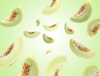 Image of Cut fresh ripe melons swirling in air against green gradient background