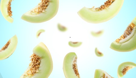 Image of Cut fresh ripe melons swirling in air against light blue gradient background