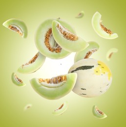 Image of Tasty ripe melons swirling in air against green gradient background