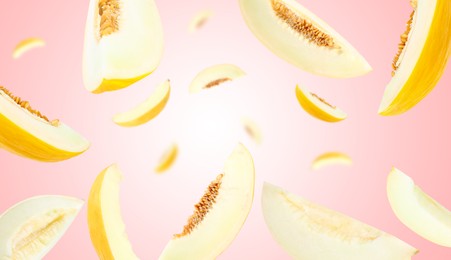 Image of Cut fresh ripe melons swirling in air against pink gradient background