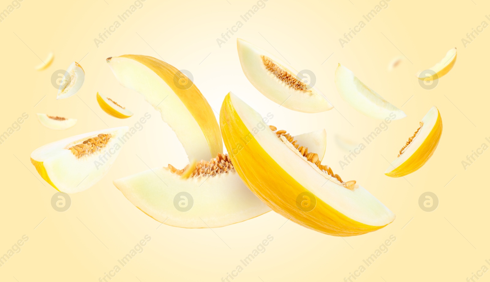 Cut fresh ripe melons swirling in air against yellow gradient background Image of Cut fresh ripe melons swirling in air against yellow gradient background