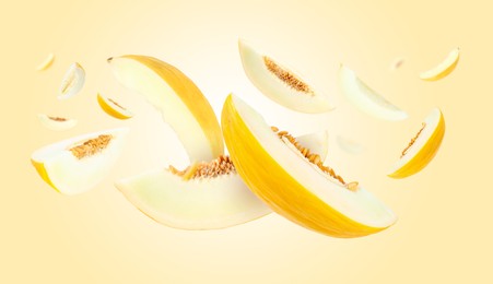 Image of Cut fresh ripe melons swirling in air against yellow gradient background