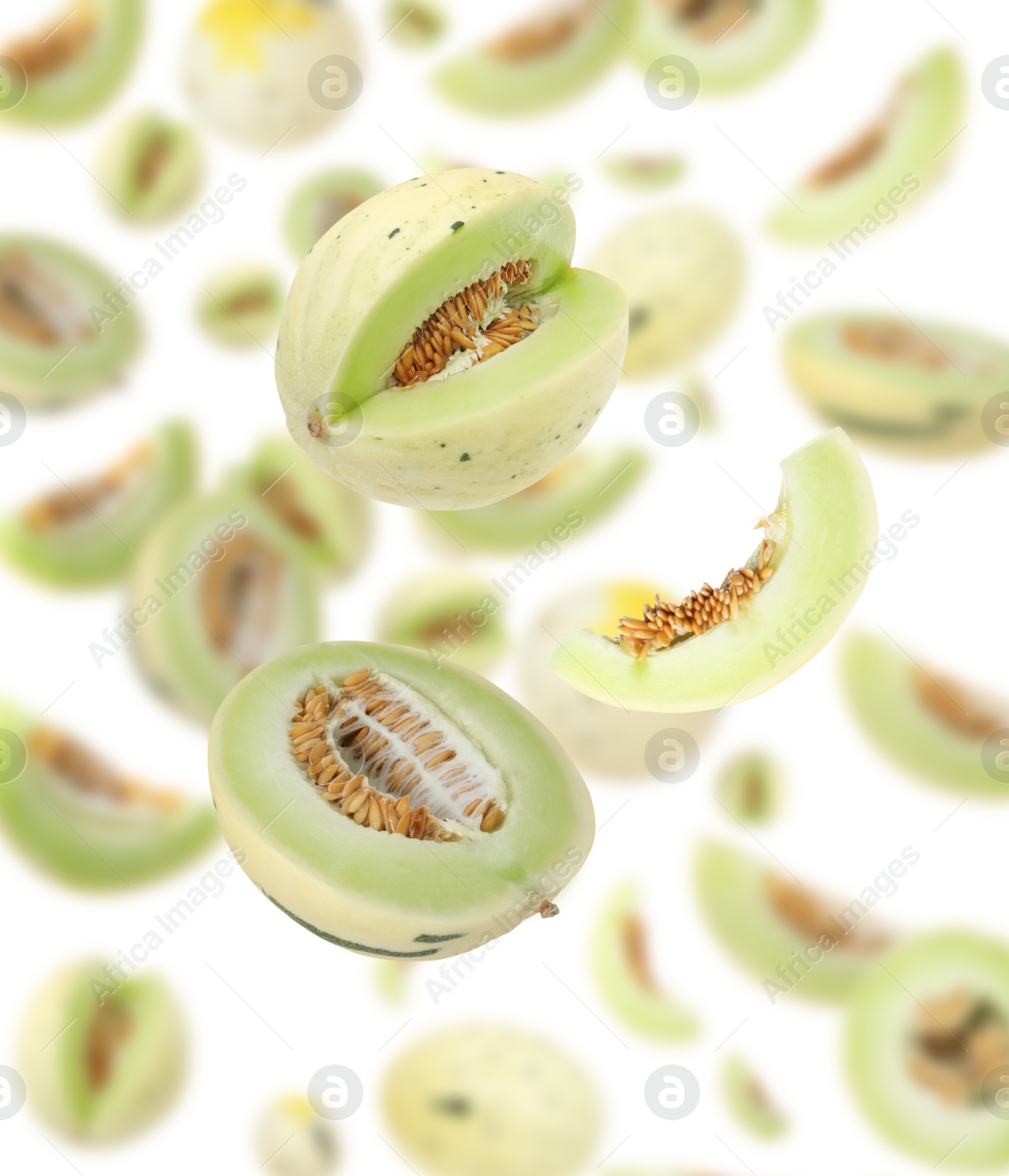 Cut fresh ripe melons swirling in air against white background Image of Cut fresh ripe melons swirling in air against white background