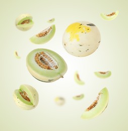 Image of Tasty ripe melons swirling in air against light green gradient background