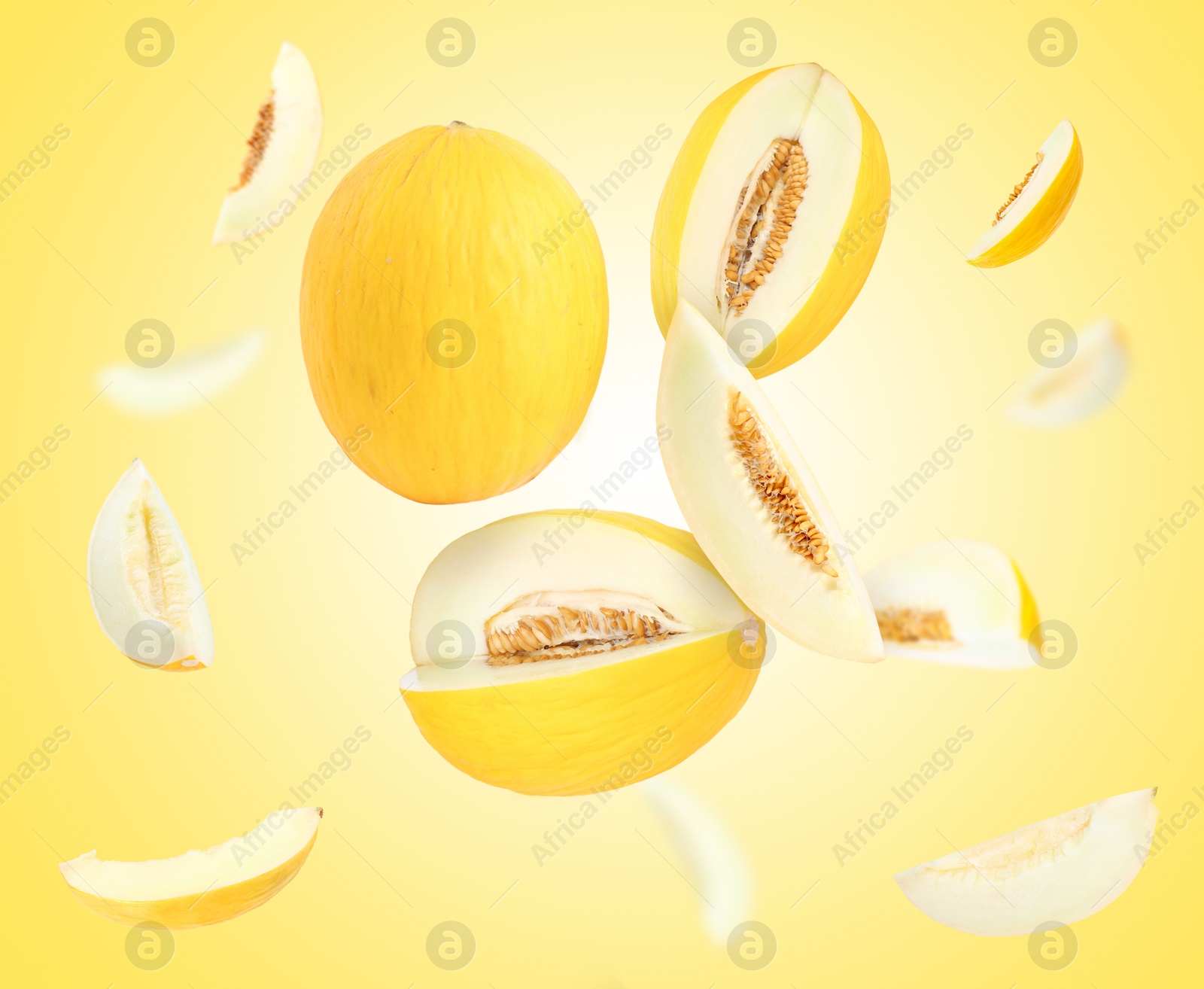 Tasty ripe melons swirling in air against yellow gradient background Image of Tasty ripe melons swirling in air against yellow gradient background