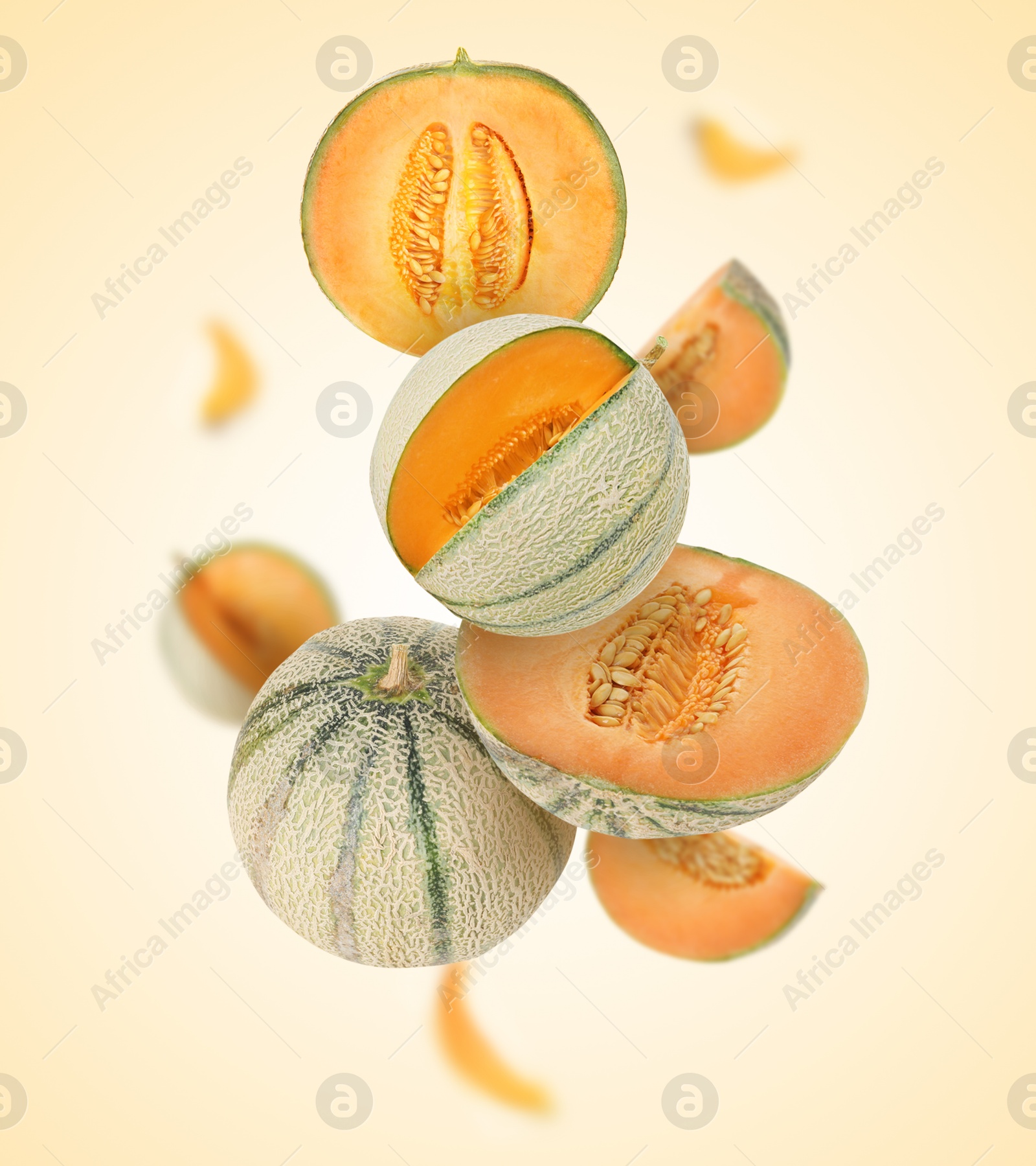 Tasty ripe Cantaloupe melons swirling in air against beige background Image of Tasty ripe Cantaloupe melons swirling in air against beige background