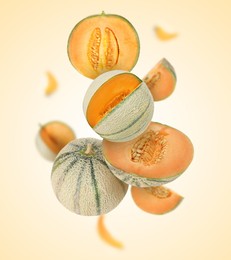 Image of Tasty ripe Cantaloupe melons swirling in air against beige background