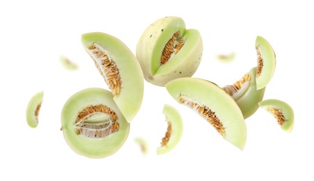 Image of Cut fresh ripe melons swirling in air against white background