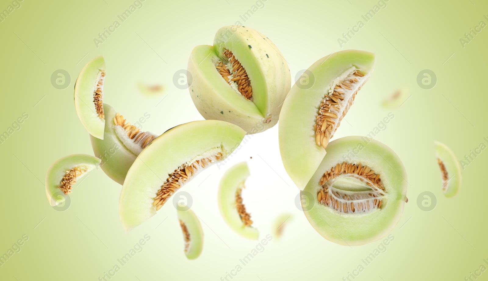 Cut fresh ripe melons swirling in air against light green gradient background Image of Cut fresh ripe melons swirling in air against light green gradient background