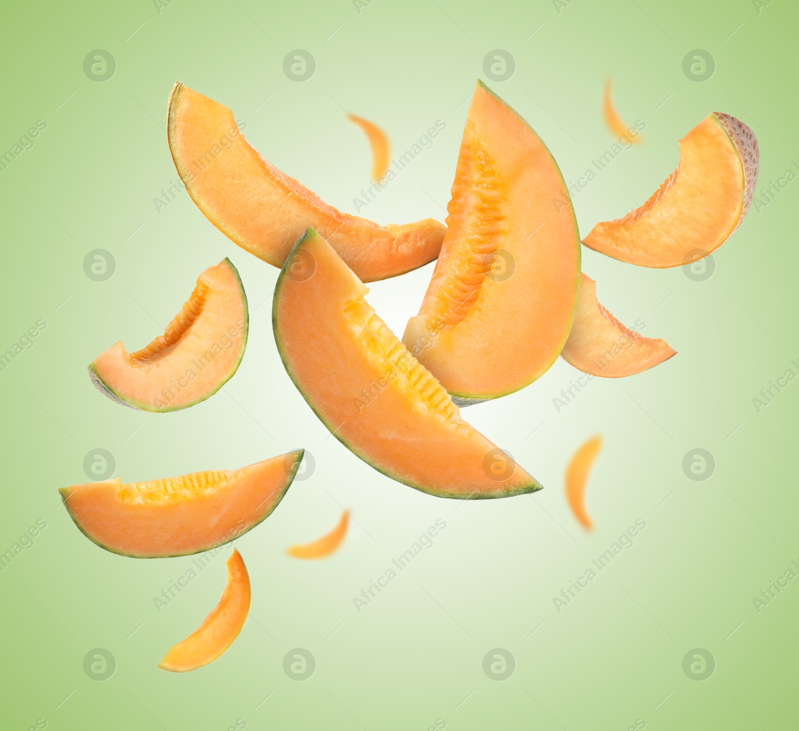 Cut fresh ripe melons swirling in air against green gradient background Image of Cut fresh ripe melons swirling in air against green gradient background