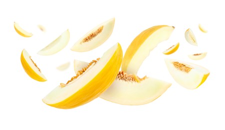 Image of Cut fresh ripe melons swirling in air against white background