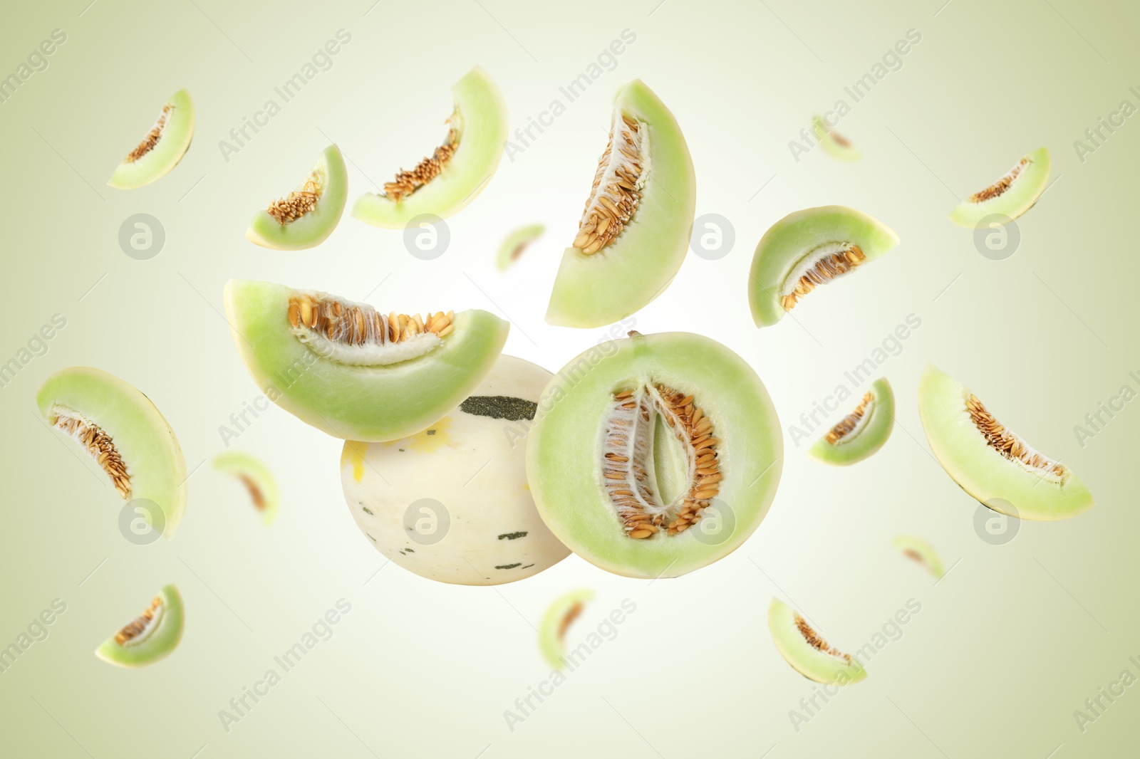 Tasty ripe melons swirling in air against light green gradient background Image of Tasty ripe melons swirling in air against light green gradient background