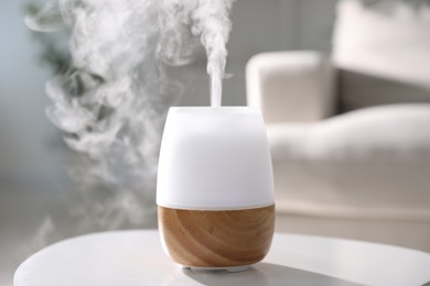 Photo of One stylish aroma lamp on white table indoors, closeup