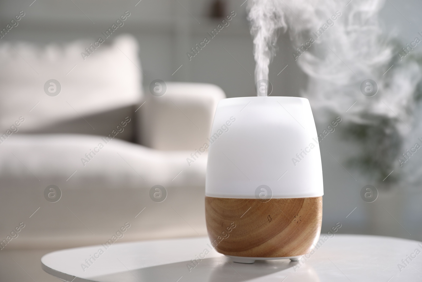 One stylish aroma lamp on white table indoors, closeup. Space for text Photo of One stylish aroma lamp on white table indoors, closeup. Space for text