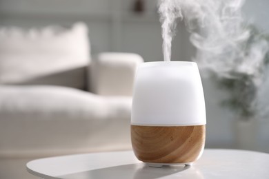 Photo of One stylish aroma lamp on white table indoors, closeup. Space for text