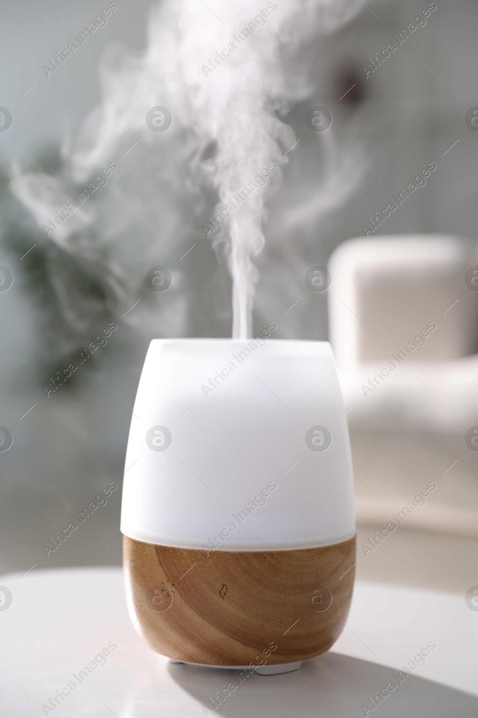 Photo of One stylish aroma lamp on white table indoors, closeup