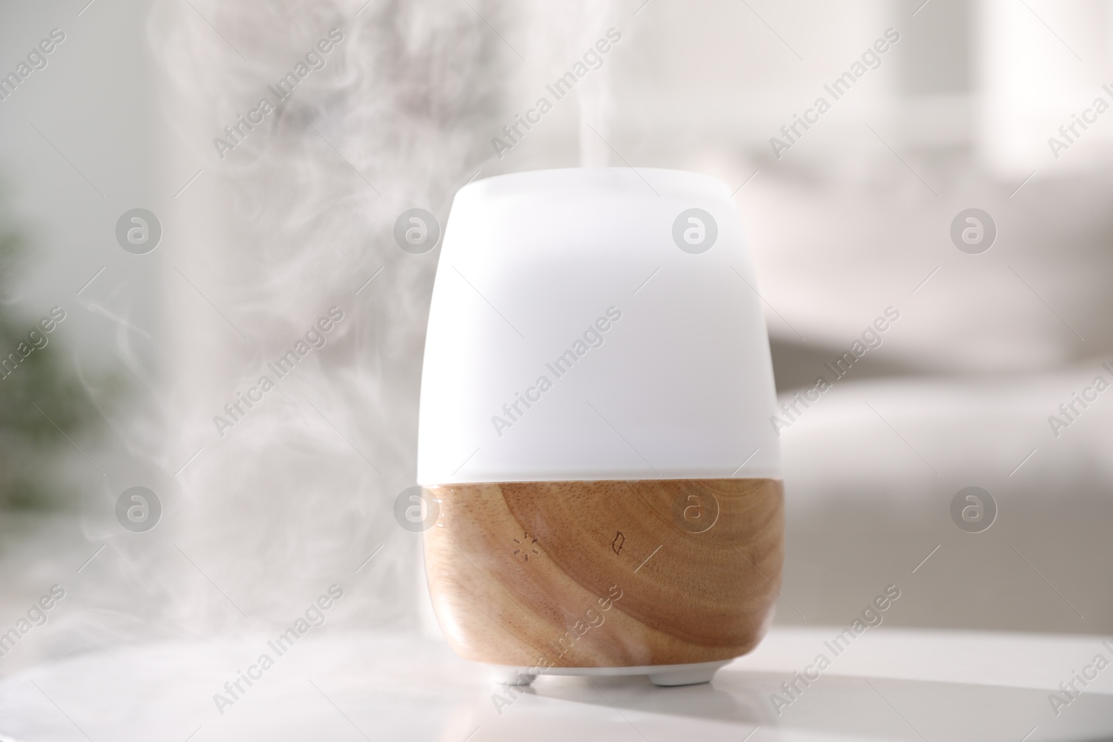 One stylish aroma lamp on white table indoors, closeup Photo of One stylish aroma lamp on white table indoors, closeup