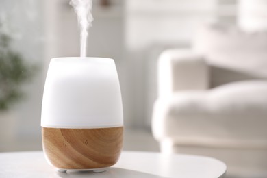 Photo of One stylish aroma lamp on white table indoors, closeup. Space for text
