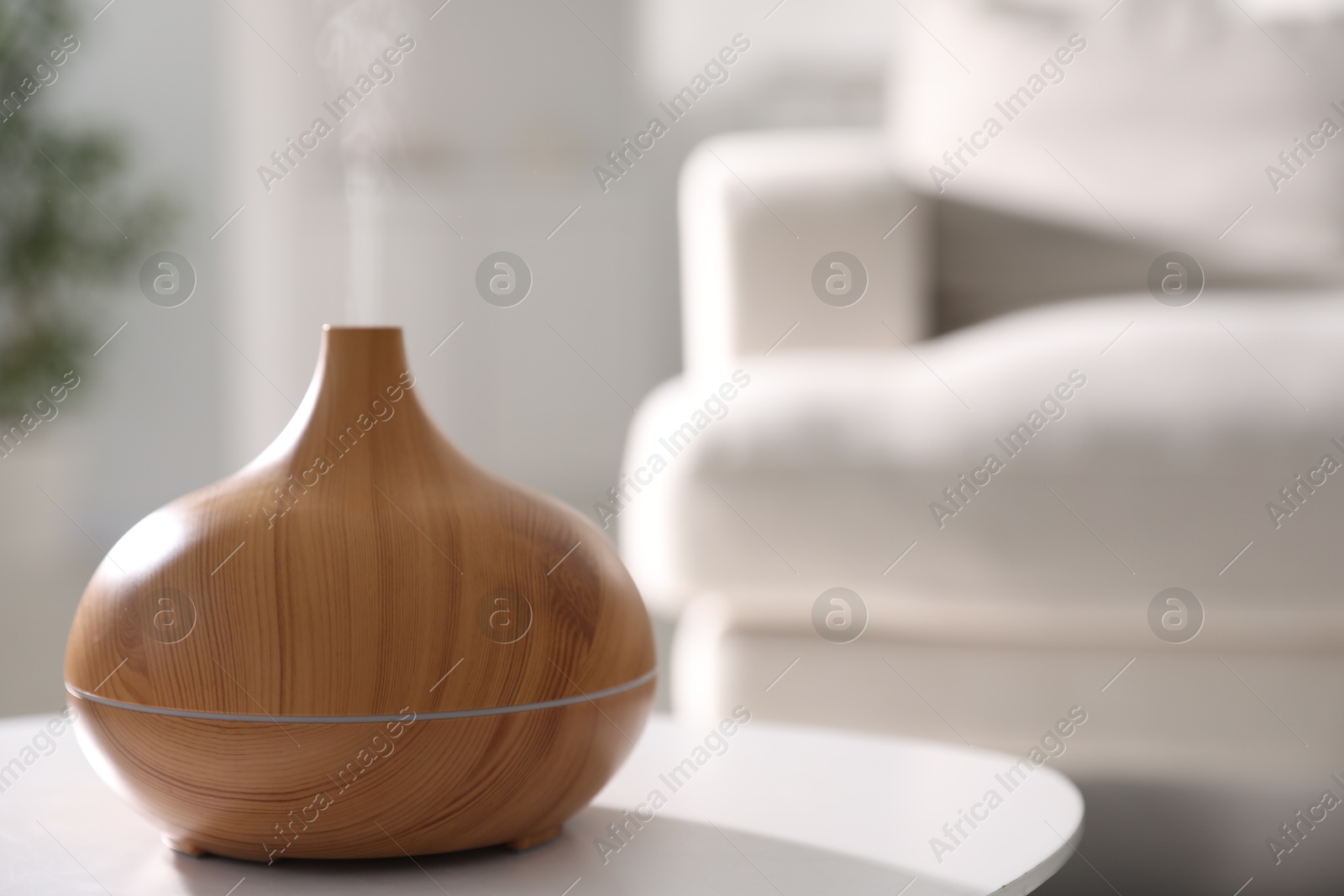 One stylish aroma lamp on white table indoors, closeup. Space for text Photo of One stylish aroma lamp on white table indoors, closeup. Space for text