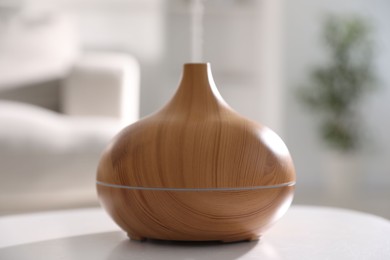 Photo of One stylish aroma lamp on white table indoors, closeup