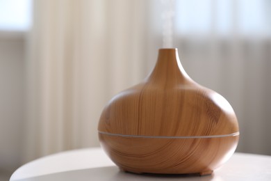Photo of One stylish aroma lamp on white table indoors, closeup