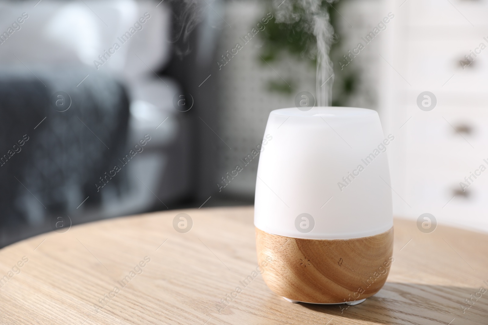 One stylish aroma lamp on wooden table indoors, closeup. Space for text Photo of One stylish aroma lamp on wooden table indoors, closeup. Space for text