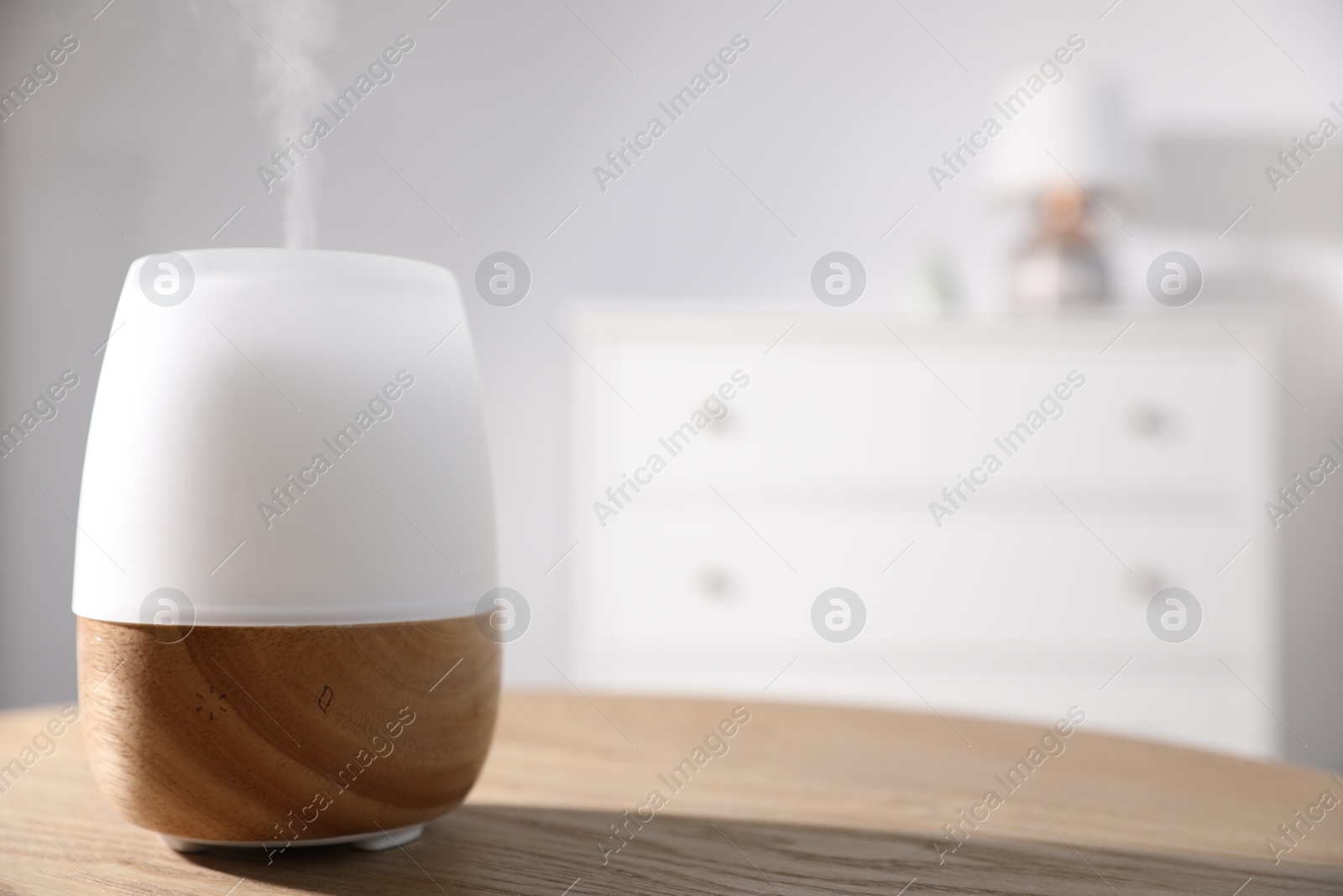 One stylish aroma lamp on wooden table indoors, closeup. Space for text Photo of One stylish aroma lamp on wooden table indoors, closeup. Space for text