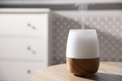 Photo of One stylish aroma lamp on wooden table indoors, closeup. Space for text