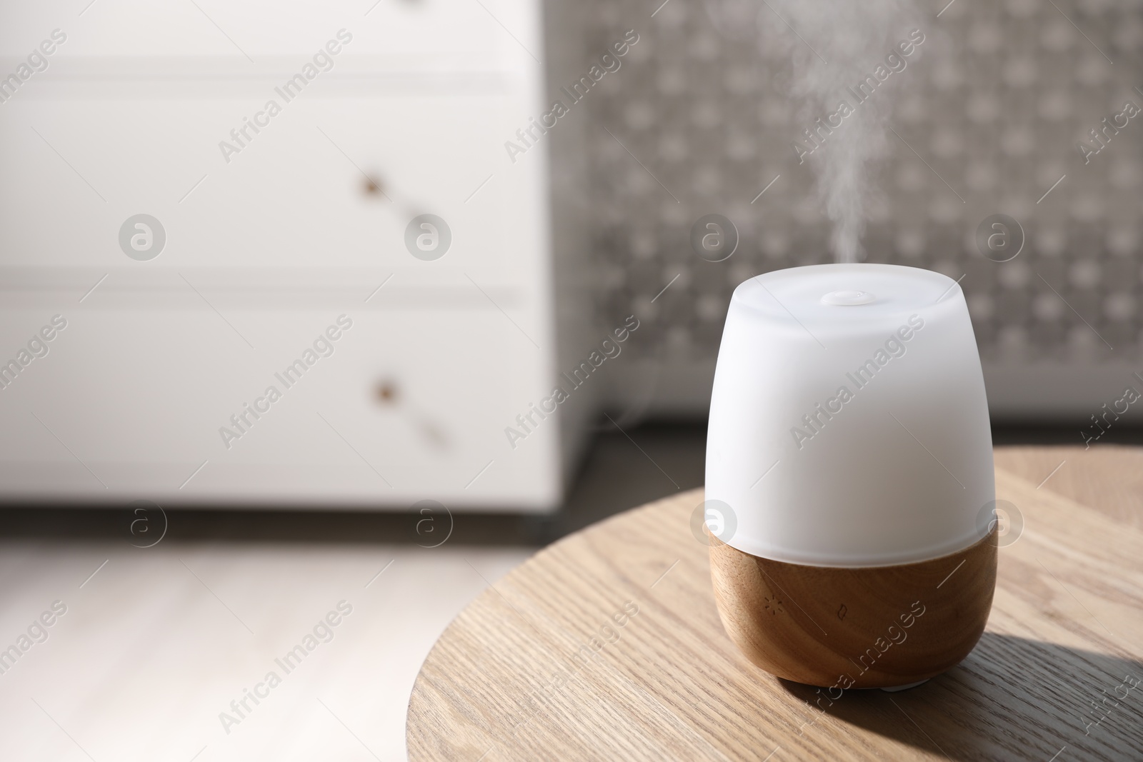 Photo of One stylish aroma lamp on wooden table indoors, closeup. Space for text