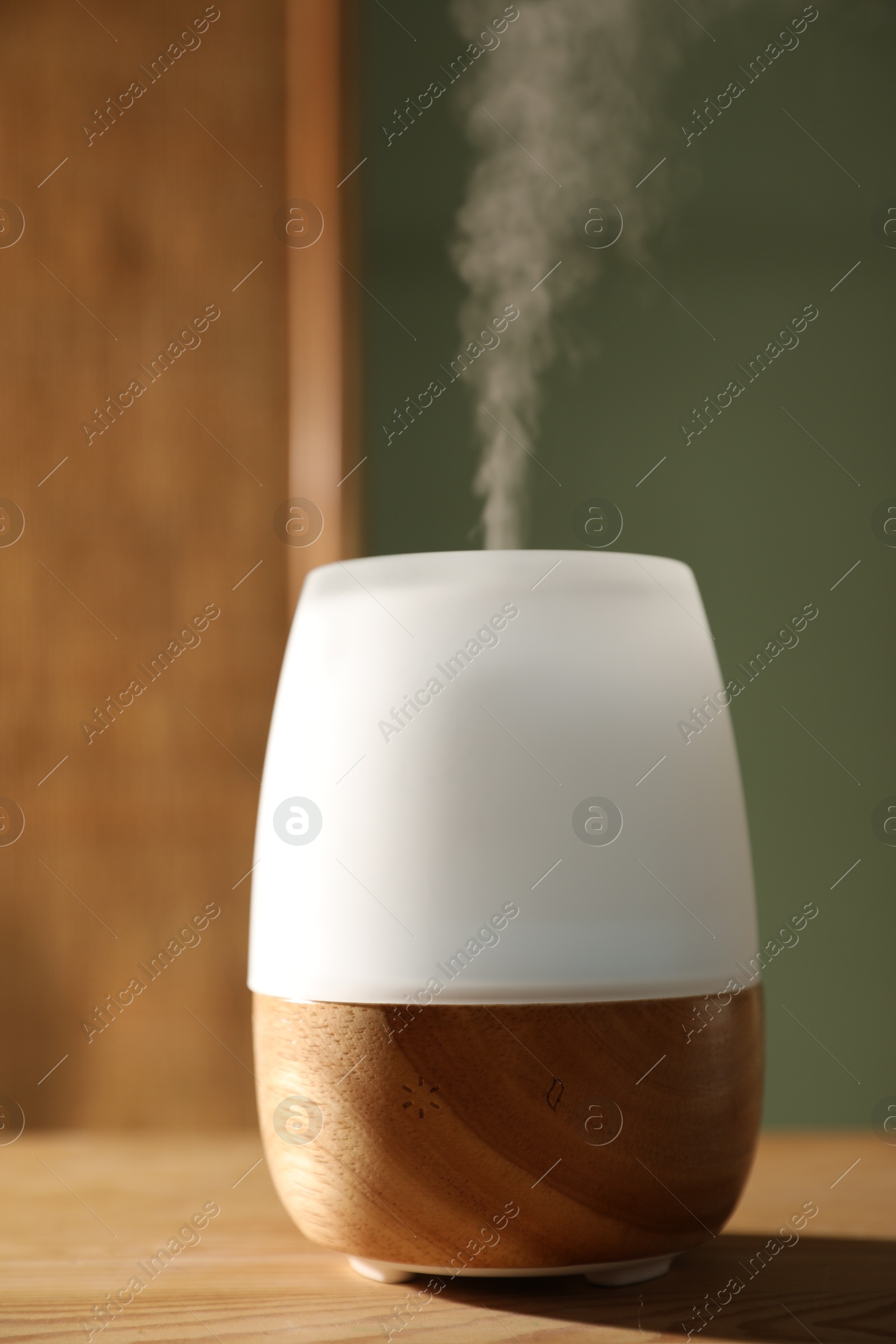 One stylish aroma lamp on wooden table indoors, closeup Photo of One stylish aroma lamp on wooden table indoors, closeup